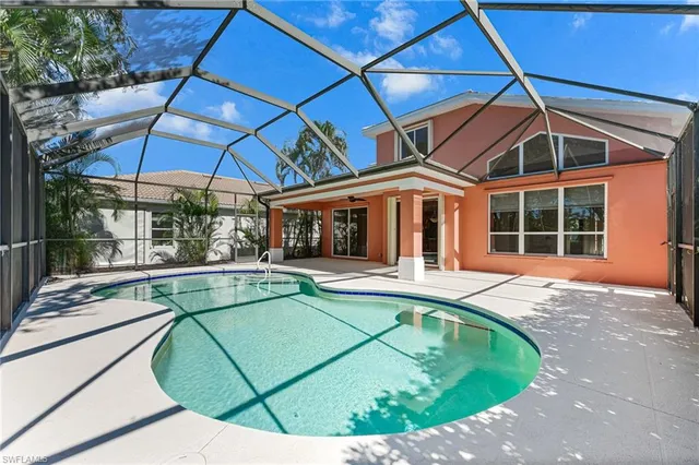 a view of a patio with a table chairs and a backyard