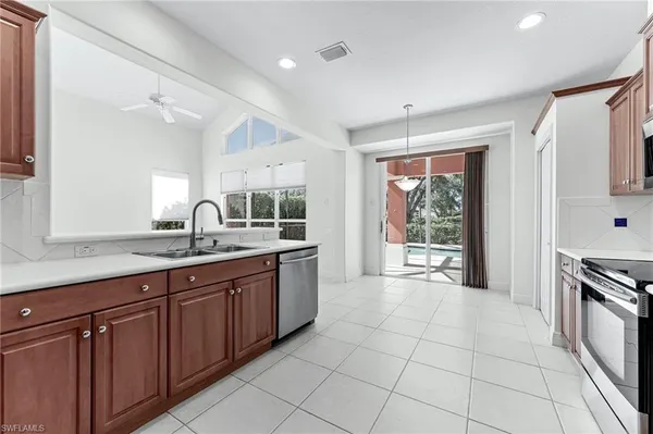 a large kitchen with granite countertop a sink and a stove