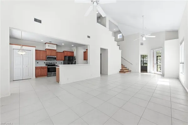 a view of a kitchen with furniture and an empty kitchen