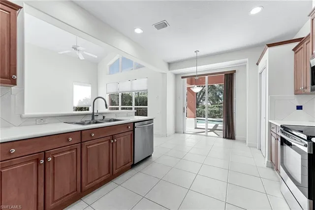 a large kitchen with granite countertop a sink and a stove
