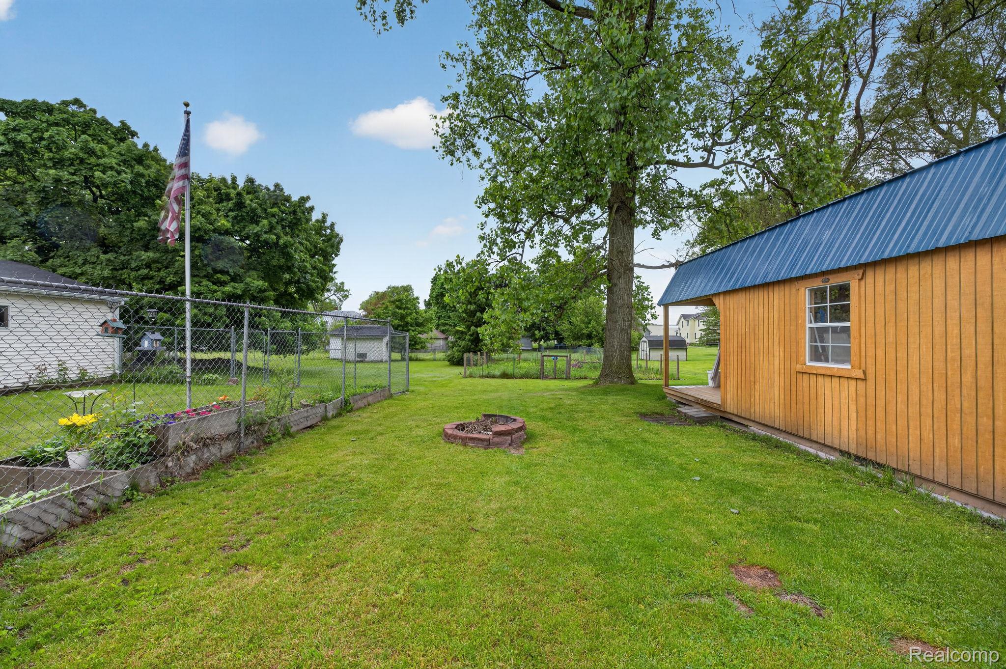 304 West Ridge Street Owosso, MI 48867 - Photo 29 of 45 View of yard with an outdoor fire pit