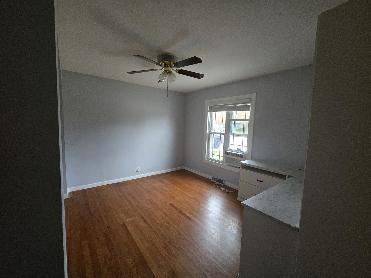 6108 Birmingham Street Chicago Ridge, IL 60415 - Photo 11 of 19 wooden floor in an empty room with a window