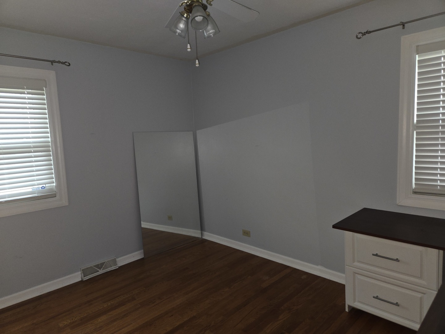 6108 Birmingham Street Chicago Ridge, IL 60415 - Photo 14 of 19 an empty room with wooden floor cabinet and windows