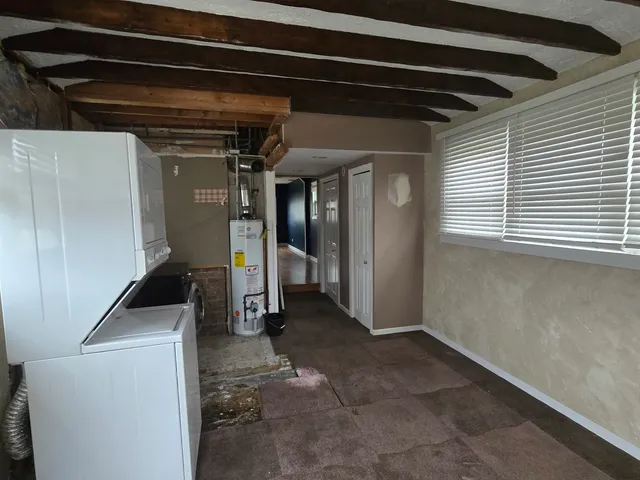 a front view of a house with a garden and yard