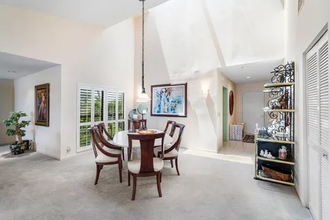 a dining room with furniture and natural light