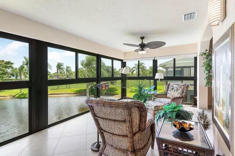a view of a dining room with furniture and chandelier fan