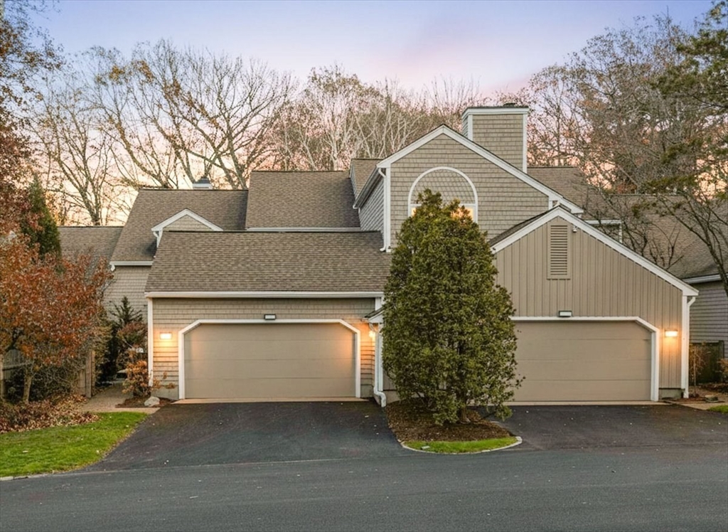 a view of a house with a yard and garage