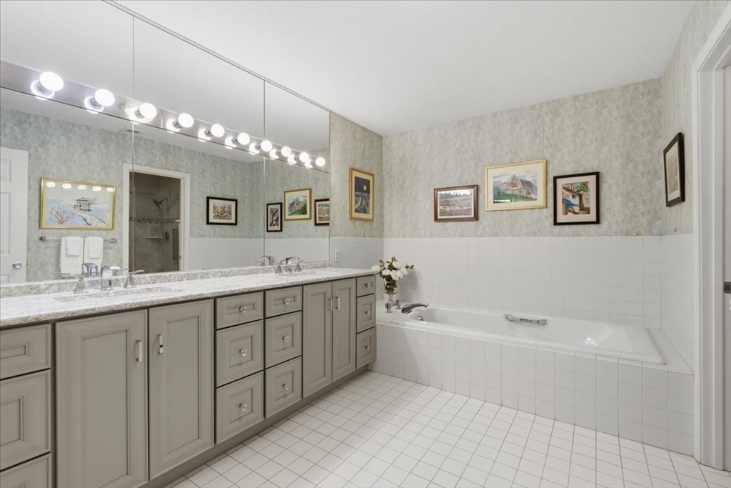 401 Dedham Street, Unit B Newton, MA 02459 - Photo 14 of 33 a spacious bathroom with a tub a double vanity sink and mirror