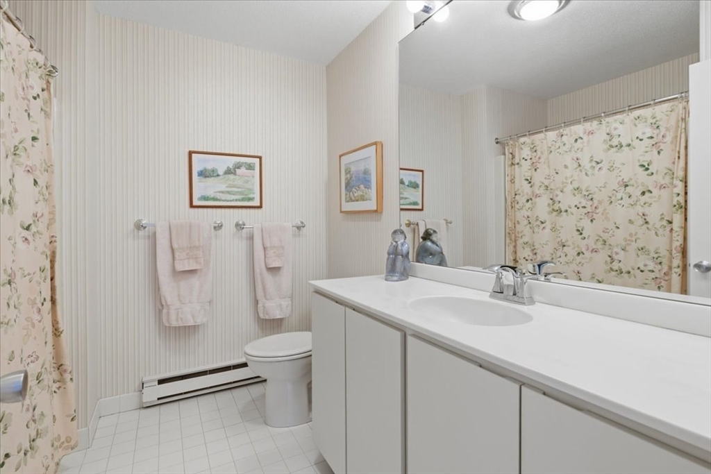 401 Dedham Street, Unit B Newton, MA 02459 - Photo 17 of 33 a bathroom with a sink toilet and shower