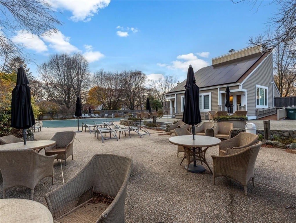 401 Dedham Street, Unit B Newton, MA 02459 - Photo 26 of 33 a view of a patio with couches and a fire pit and chairs