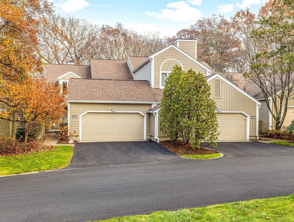 401 Dedham Street, Unit B Newton, MA 02459 - Photo 29 of 33 a front view of a house with a yard and garage