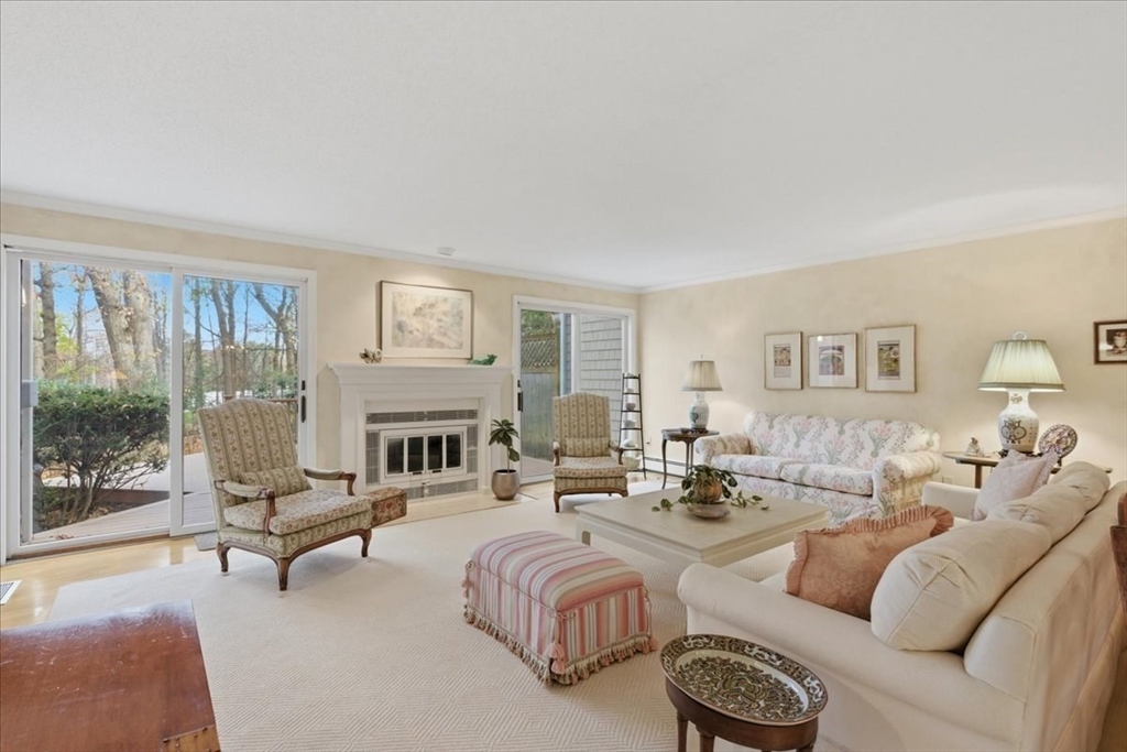 401 Dedham Street, Unit B Newton, MA 02459 - Photo 4 of 33 a living room with furniture large window and a fireplace