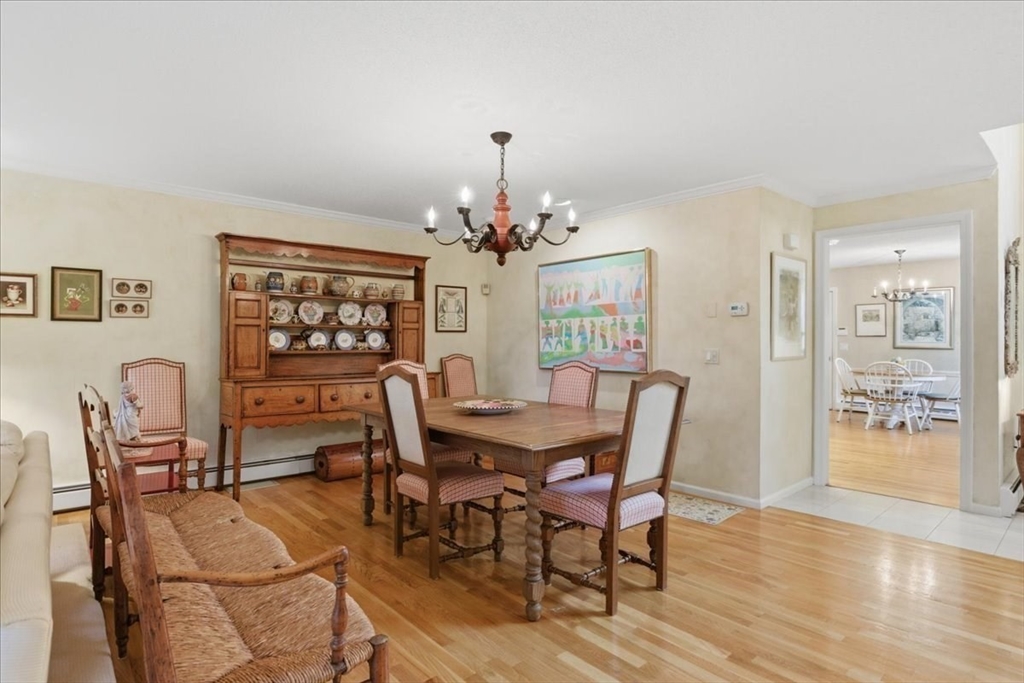 401 Dedham Street, Unit B Newton, MA 02459 - Photo 5 of 33 a dining room with furniture a chandelier and wooden floor