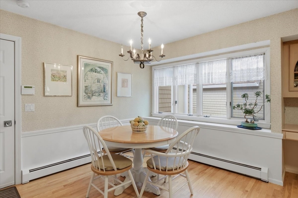 401 Dedham Street, Unit B Newton, MA 02459 - Photo 9 of 33 a view of a dining room with furniture window and wooden floor