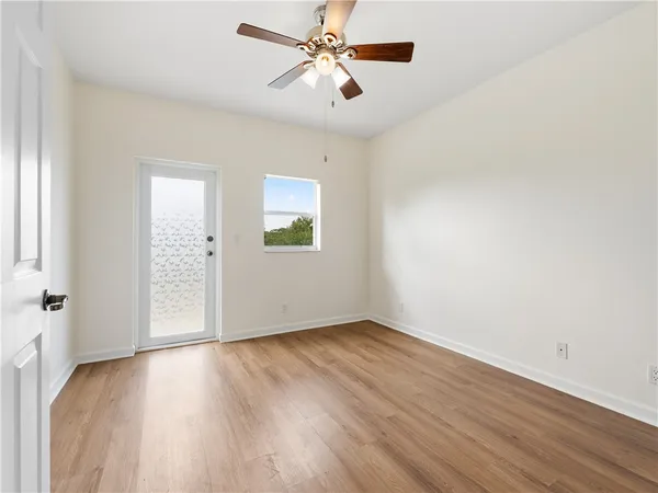 wooden floor in an empty room with a window