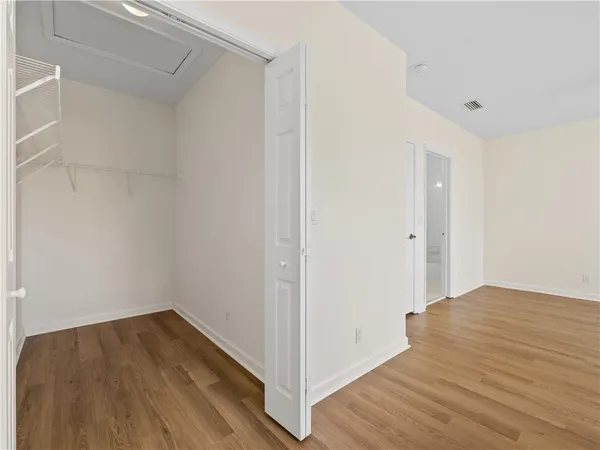 a view of a room with wooden floor