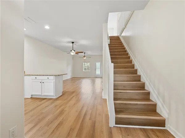 a view of entryway and hall with wooden floor
