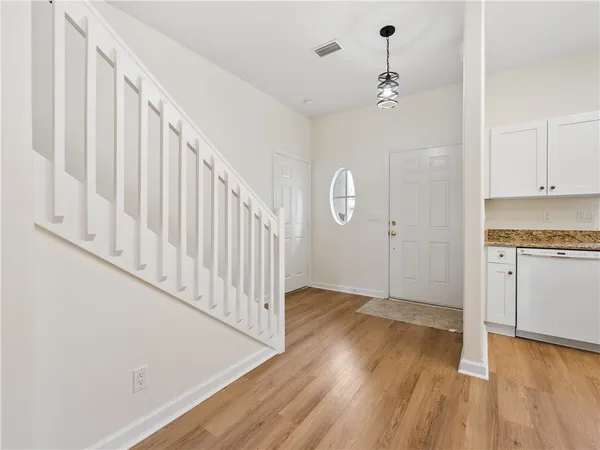 a view of an entryway with wooden floor