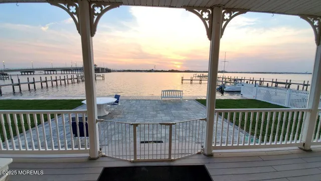 a view of a balcony with wooden floor and lake view