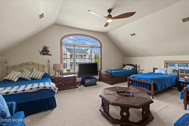 a living room with furniture a flat screen tv and a window