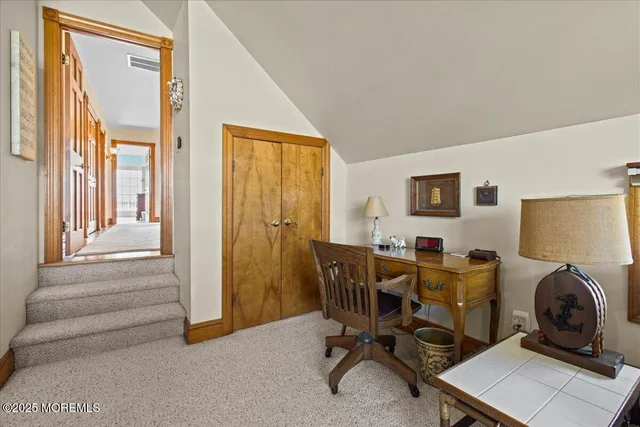 a bathroom with a sink a toilet a mirror and a window