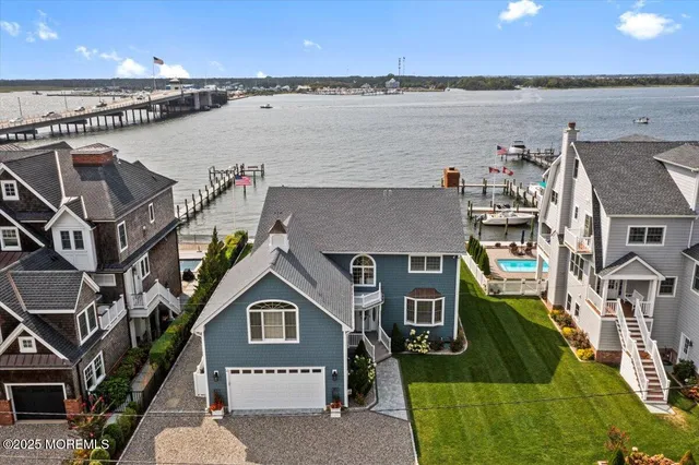 an aerial view of a house with a garden and outdoor seating