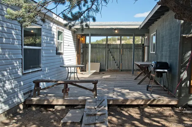 a view of a patio with table and chairs and potted plants