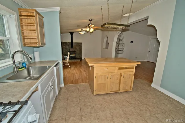 a kitchen with a sink and a stove top oven
