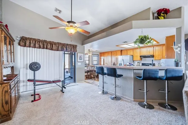 a living room with furniture a dining table and a chandelier