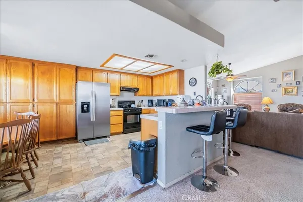 a kitchen with stainless steel appliances granite countertop a sink and cabinets