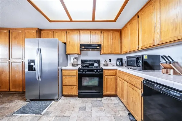 a kitchen with stainless steel appliances granite countertop sink stove and cabinets