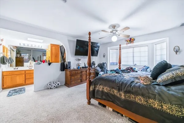 a bedroom with furniture and a flat screen tv