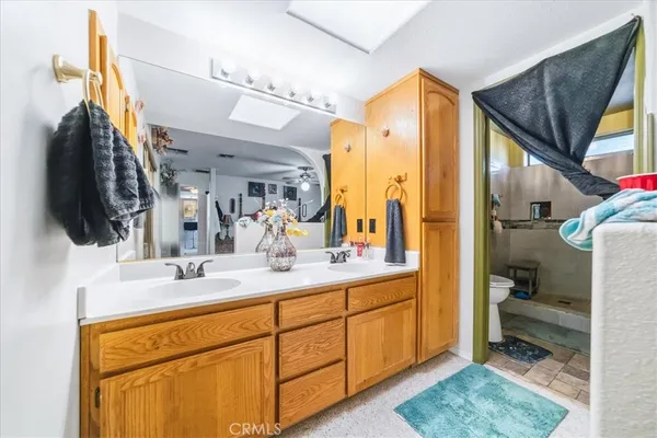 a white toilet sitting next to a bathroom sink and a tub