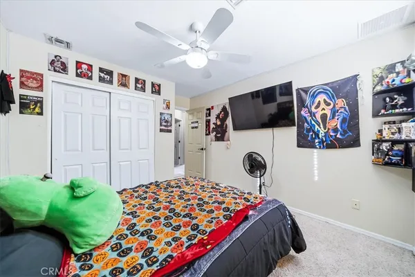 a bedroom with a bed and a baby bed