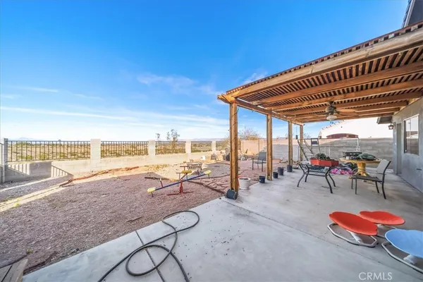 a view of a house with backyard porch and sitting area