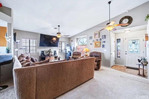 a living room with furniture and kitchen view