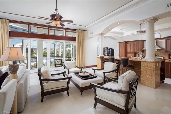 a living room with furniture a fireplace and a chandelier