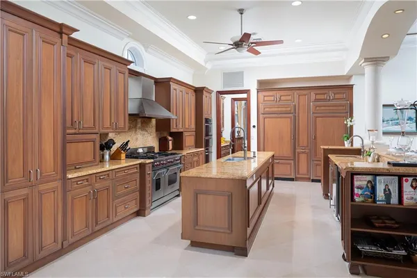 a open kitchen with stainless steel appliances granite countertop a stove cabinets and living room view