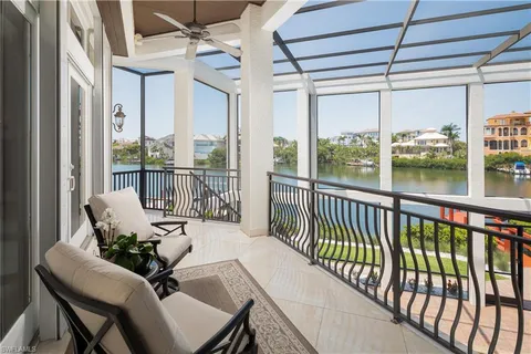 a balcony with furniture and a potted plant