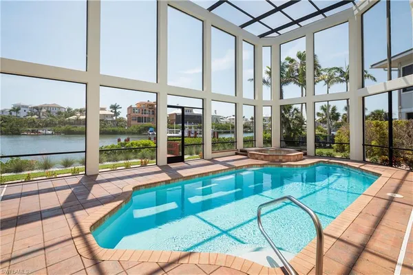 a swimming pool with chairs and couch
