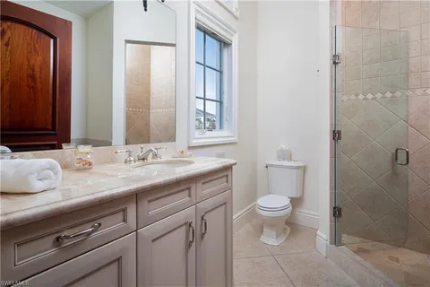 a bedroom with a large bed and a large window