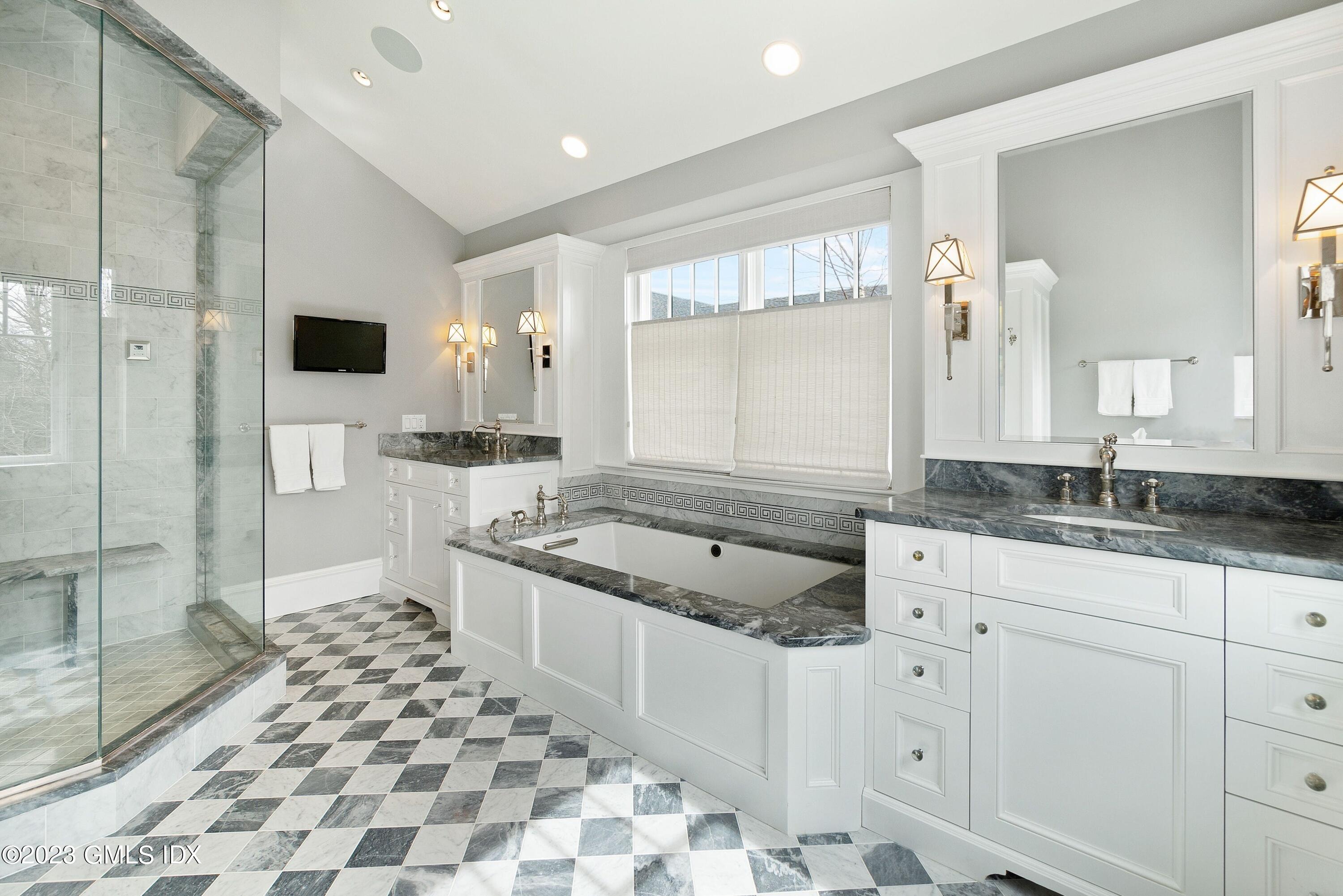 6 Cherry Lane Old Greenwich, CT 06870 - Photo 18 of 31 a spacious bathroom with a granite countertop sink a mirror and a shower