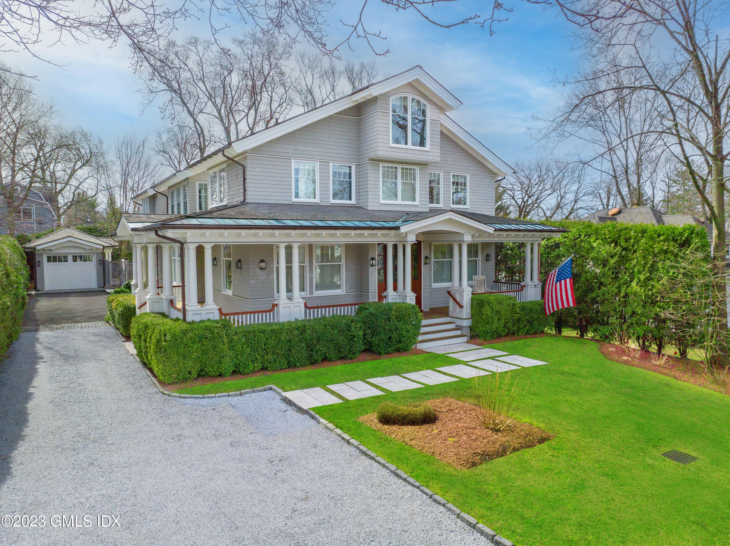 6 Cherry Lane Old Greenwich, CT 06870 - Photo 2 of 31 a front view of a house with a yard table and chairs