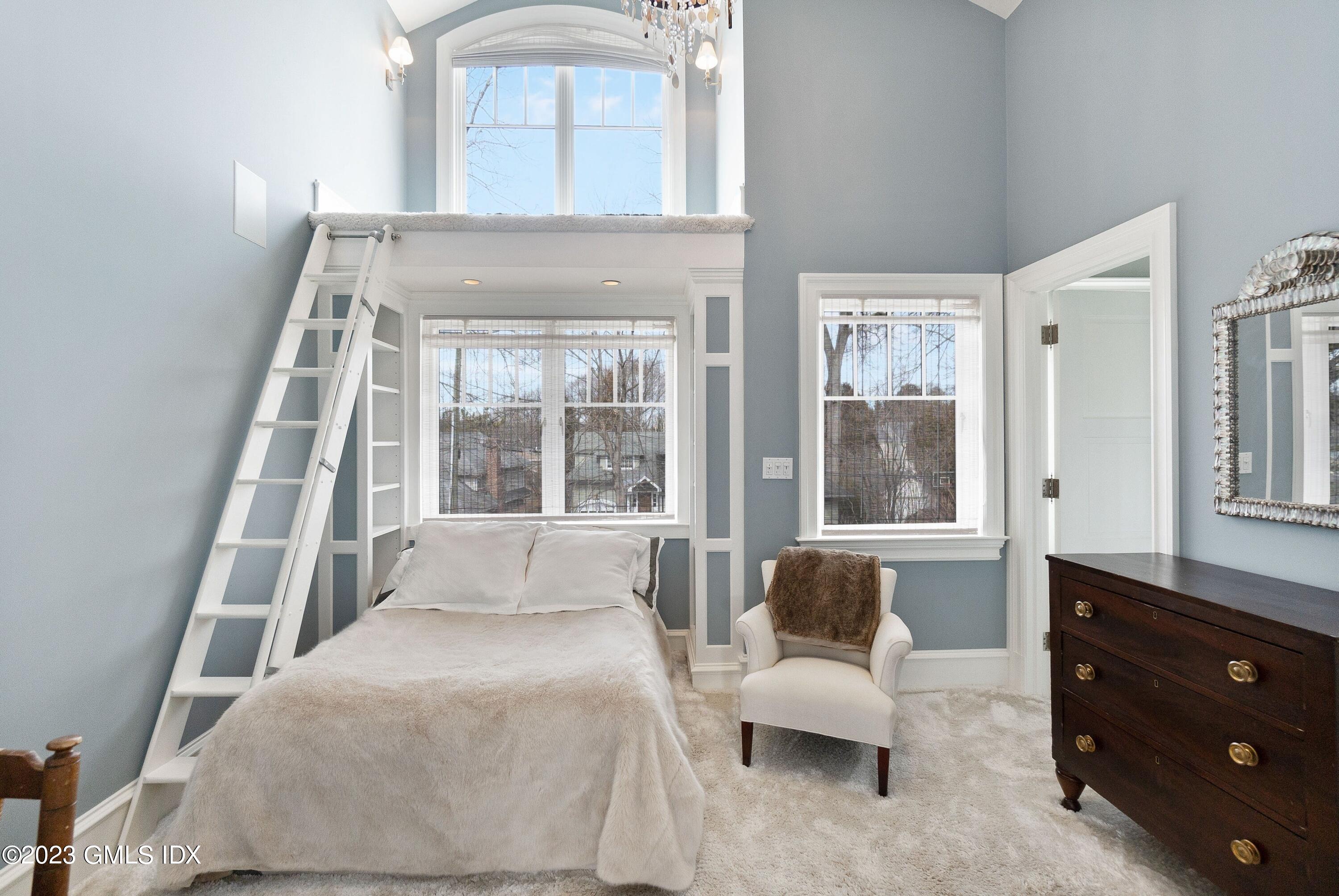 6 Cherry Lane Old Greenwich, CT 06870 - Photo 21 of 31 a bedroom with a bed and large window