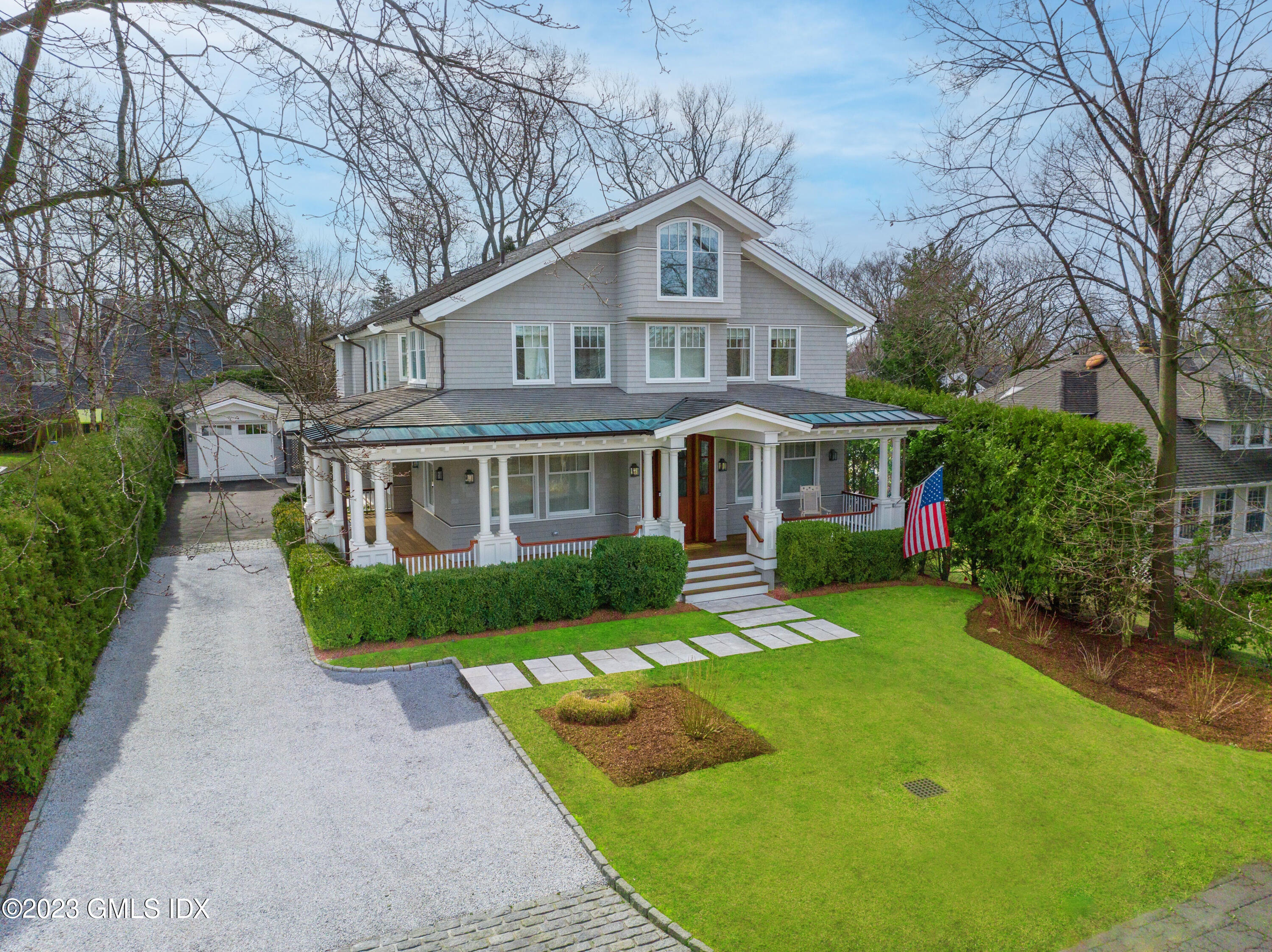 6 Cherry Lane Old Greenwich, CT 06870 - Photo 27 of 31 a front view of a house with a yard table and chairs