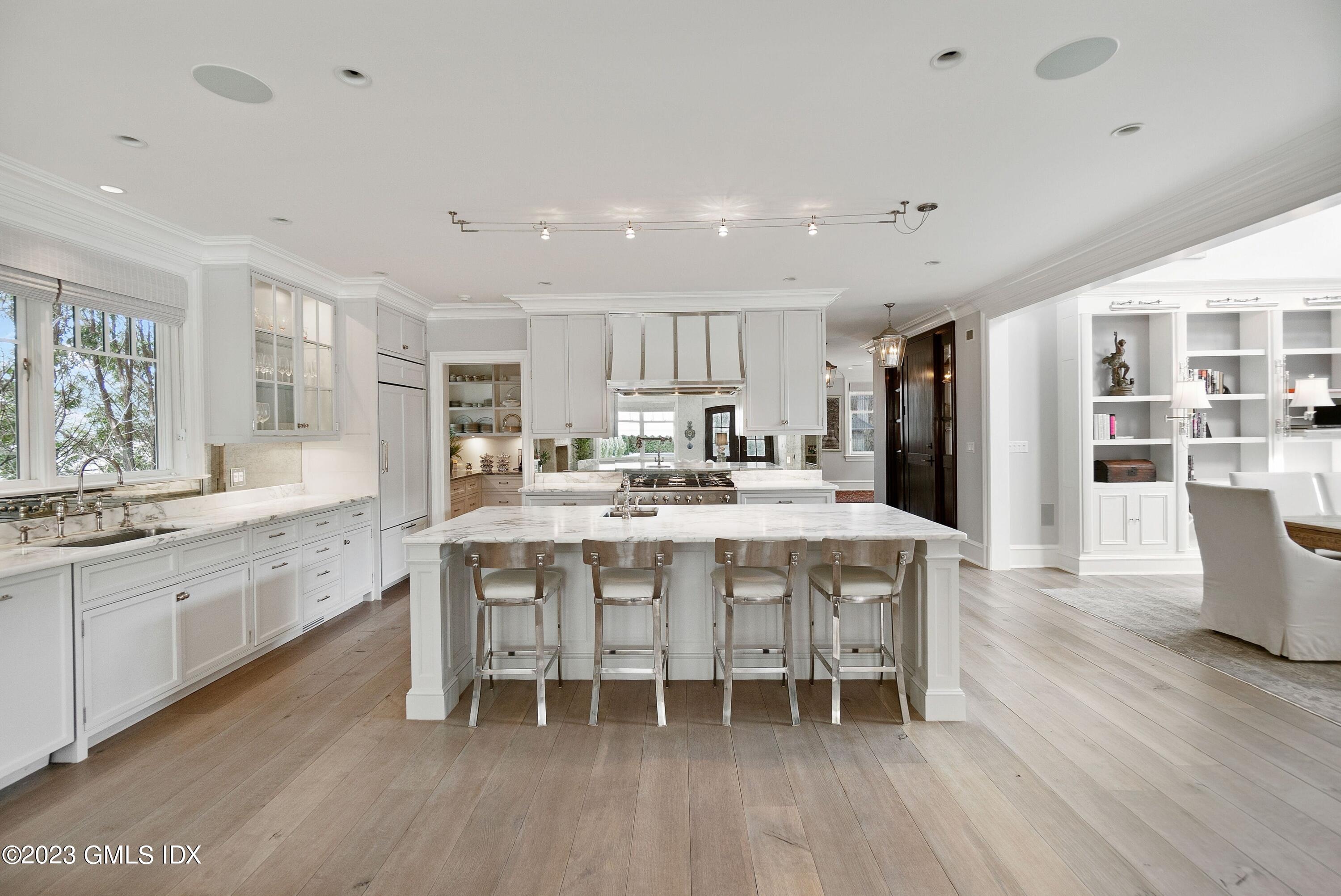 6 Cherry Lane Old Greenwich, CT 06870 - Photo 6 of 31 a kitchen with stainless steel appliances granite countertop a dining table chairs stove refrigerator and cabinets