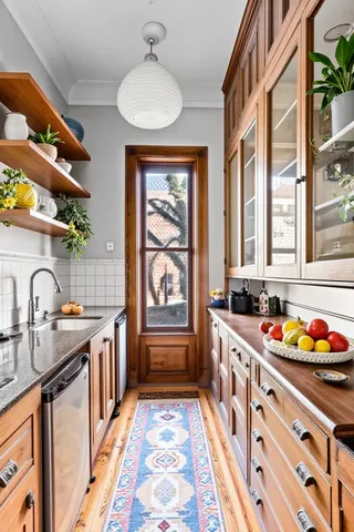 a living room with furniture a fireplace and a book shelf
