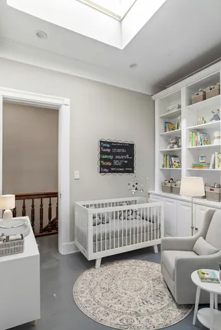 a bedroom with a bed and a painting on the wall