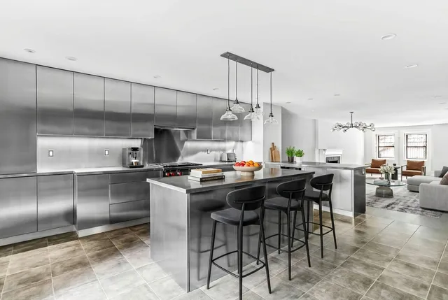 a living room with patio fireplace and a flat screen tv