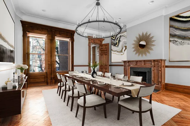 a living room with furniture and a painting on the wall